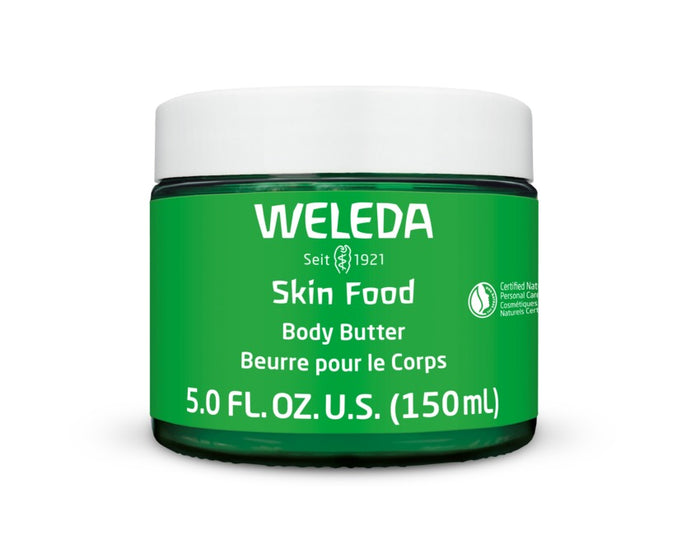 A jar of Weleda Skin Food Body Butter with a green label. The label includes “Seit 1921,” “5.0 FL. OZ. U.S. (150ml),” and certification symbols. The product is intended for body care.