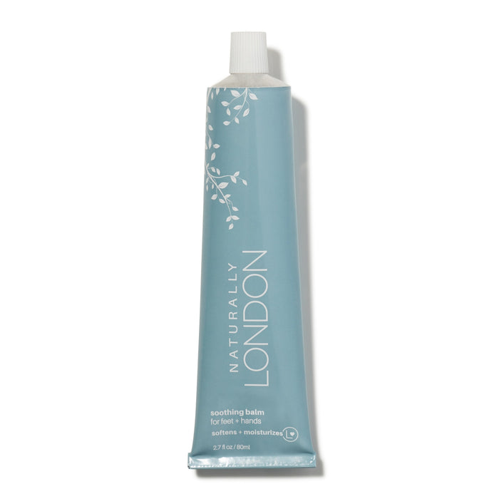 A light blue tube of Naturally London soothing balm for feet and hands, featuring white botanical graphics and white text, with a white cap. The tube is upright on a white background.