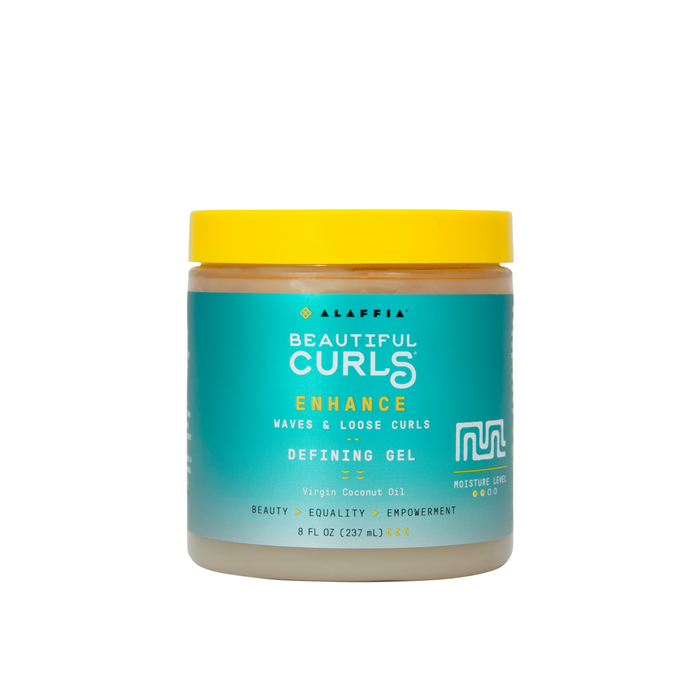 A jar of Alaffia Beautiful Curls Defining Gel with a yellow lid and teal label, designed for enhancing waves and loose curls. The label highlights moisture level, virgin coconut oil, and empowerment messaging.