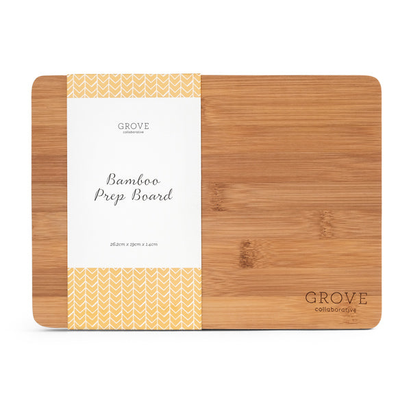 Rectangular bamboo prep board with rounded corners. Partly wrapped in a white and yellow paper label that reads Grove Collaborative Bamboo Prep Board. The board has a natural wood finish.
