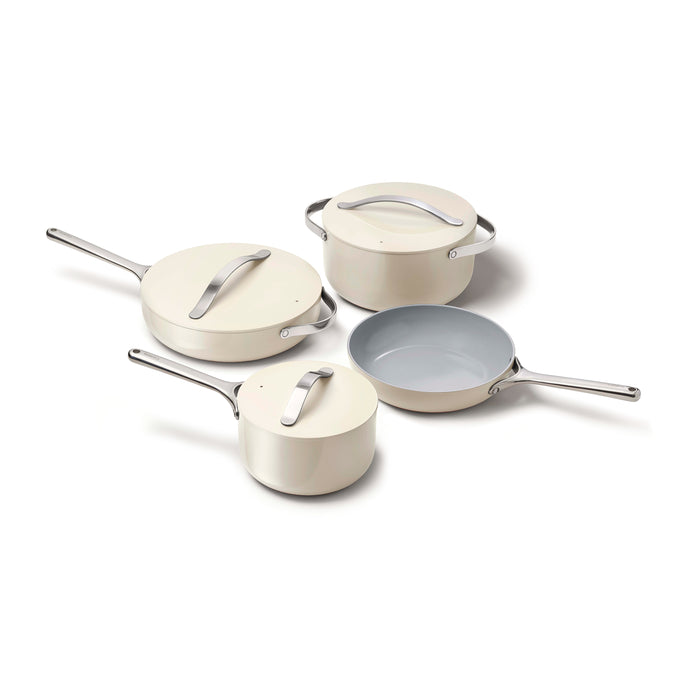 A set of four cream-colored cookware pieces with silver handles and lids, including a frying pan, a saucepan, a sauté pan, and a Dutch oven, arranged on a white background.