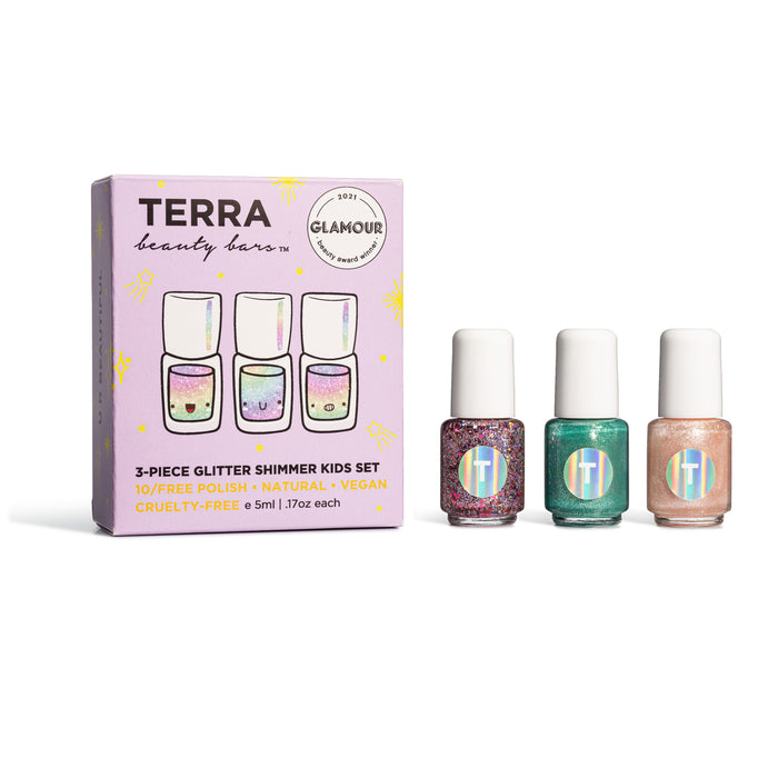 A box labeled Terra Beauty Bars 3-Piece Glitter Shimmer Kids Set is shown next to three bottles of glitter nail polish in pink, green, and peach shades. The packaging highlights that the set is vegan and cruelty-free.