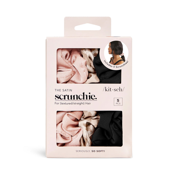 A box of five satin scrunchies by kit•sch, labeled for textured or straight hair. The box shows pink, black, and patterned scrunchies and features an image of a woman wearing one. Text reads, Seriously, so soft!.