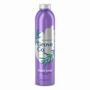 A tall metal bottle of Grove Co. Hydrating Hand Soap in purple, featuring a silver cap and a label with green sprigs that reads Go Beyond Plastic and Lavender Blossom & Thyme. This 24 fl oz (710 mL) soap is plant-based, offering a gentle clean without harsh chemicals.