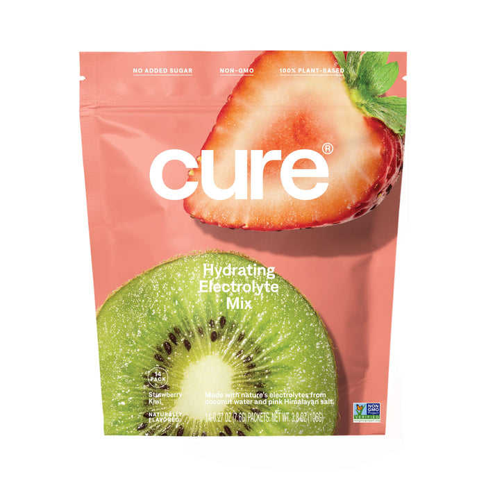 A pink pouch labeled Cure Hydrating Electrolyte Mix features large images of a strawberry and a kiwi. The packaging notes its non-GMO, plant-based, has no added sugar, and displays a Non-GMO Project Verified badge.