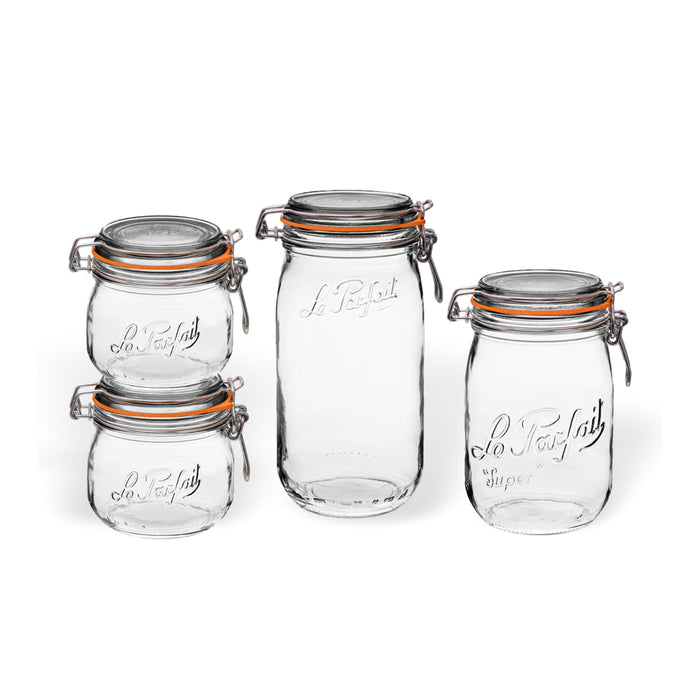 Four clear glass jars of varying sizes with metal clasps and orange rubber seals are arranged in a group. The jars are embossed with Le Parfait on the front.