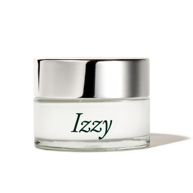 The Dew Bomb Glowy Hydra-Milk Starter Kit by IZZY Zero Waste Beauty features a small glass jar with a shiny silver lid and green Izzy text. It contains white cream infused with triple-layer hyaluronic acid, ideal for deep hydration and leaving your skin with a glowy finish.