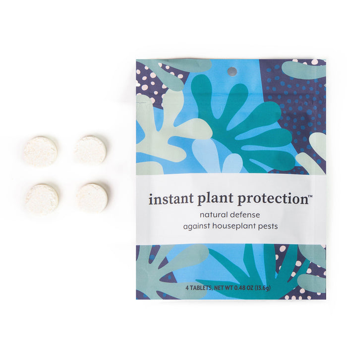 A colorful packet labeled instant plant protection, with four white tablets placed to the left. The packaging features abstract leaf shapes in green, blue, and purple, and mentions defense against houseplant pests.