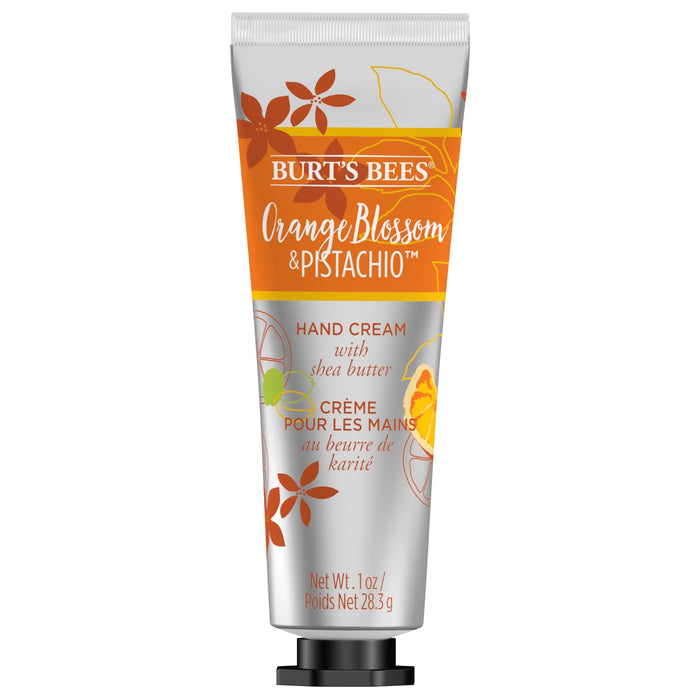 A tube of Burt’s Bees Orange Blossom & Pistachio Hand Cream with shea butter, featuring orange floral graphics and bilingual English and French text. The tube contains 1 oz (28.3 g).