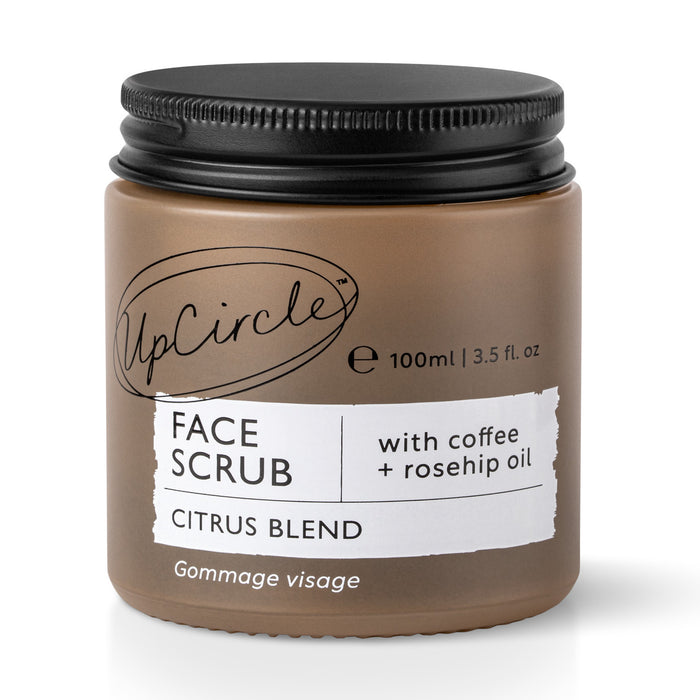 A brown glass jar of UpCircle Face Scrub, Citrus Blend, labeled as containing coffee and rosehip oil. The jar has a black screw cap and holds 100ml (3.5 fl. oz). The label features bold and cursive text.